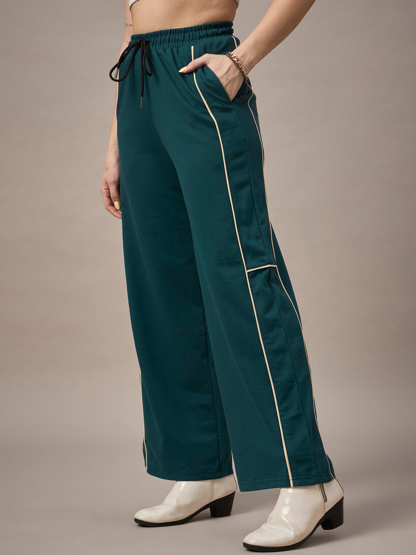 Close-up of fabric and drawcord waistband on teal womenÃ¢â‚¬â„¢s track pants